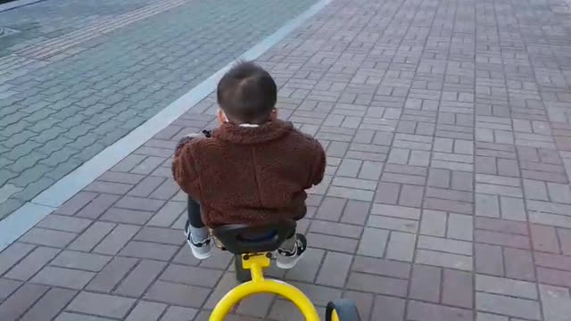 A baby riding a bicycle