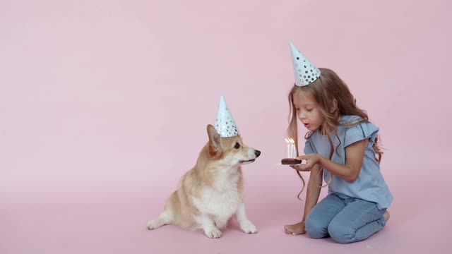 A Girl and a Dog Wearing Party Hats