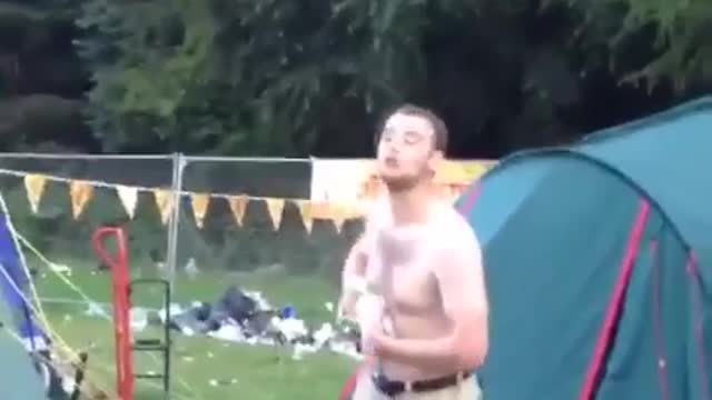 Shirtless guy gets beer spilled on himself