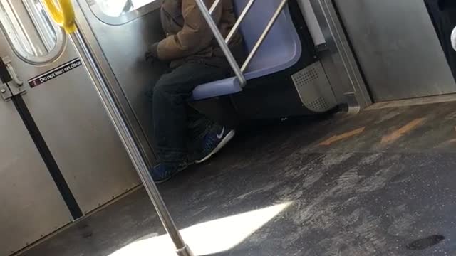 Man lights up a cigarette inside subway train