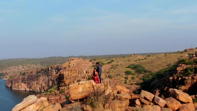 Couple On a Rock On Top of a Hill