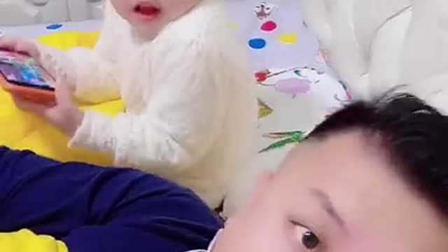 look at this very funny baby trolling his father watch