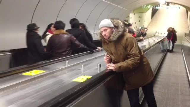 Sleepy parka man falls down escalator ramp