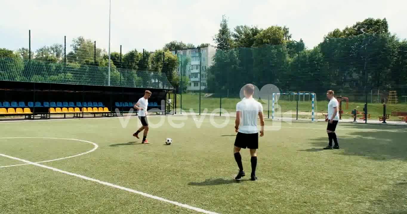 Male Soccer Player Doing A Throw In And Then Joining His Team On A Street Football Pitch