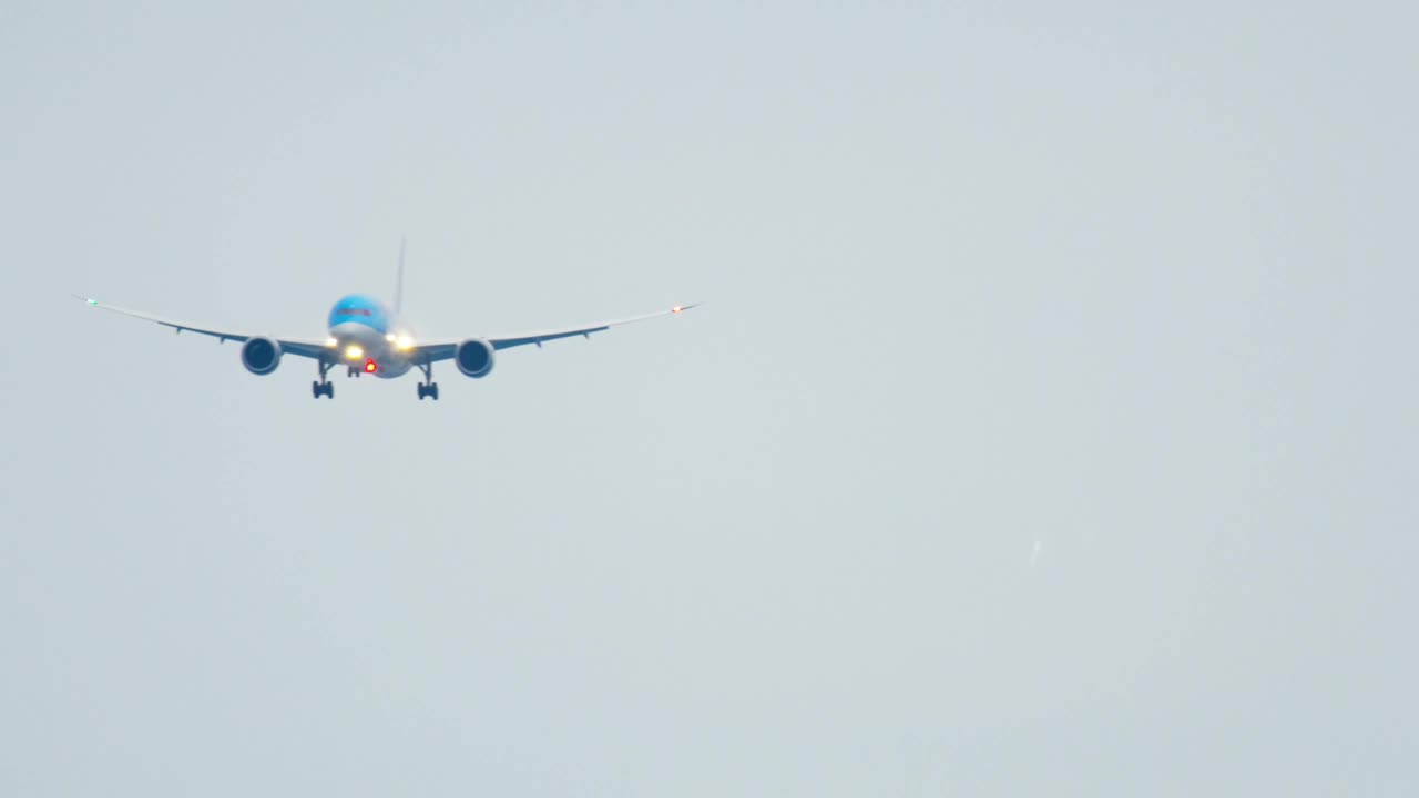 Airplane with lights on is crossing the sky