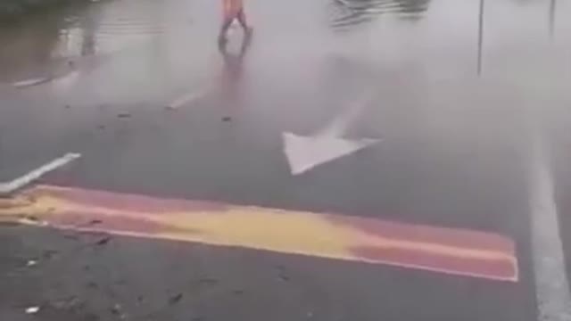 Malaysia flood light moment . Catching fish on highway