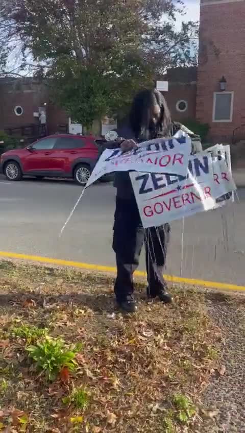 New York Woman in Police Uniform Takes Down "Lee Zeldin for Governor" Signs