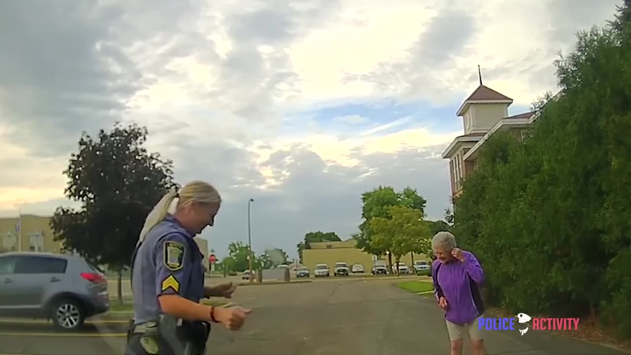 Police Sergeant Joins Woman Dancing Alone in Street