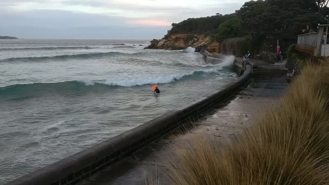 Kids Catch Waves Using Seawall