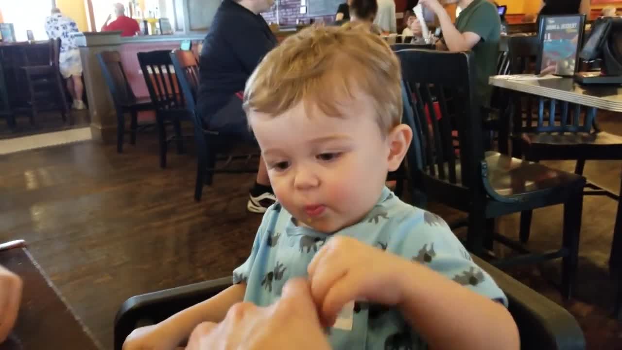 Baby bites first time in a lemon