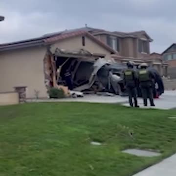 Moment when a car went airborne before crashing into a home garage in Jurupa Valley, California