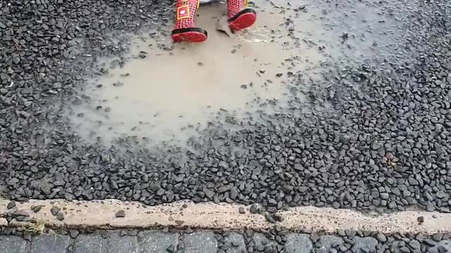 Baby Playing in the Rain and Muddy Puddle
