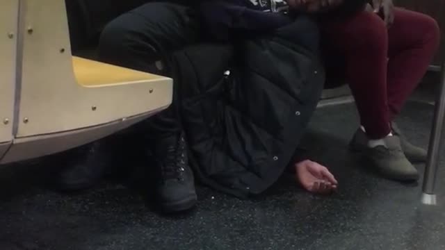 Two guys sleeping on a subway train
