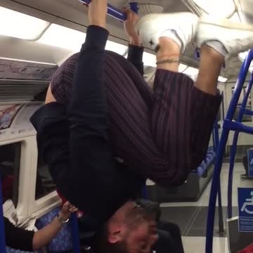 Man does back flip on blue hand rails subway