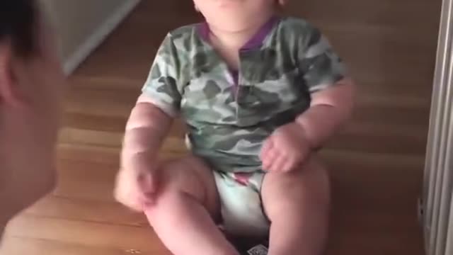 baby laughing looking at his mothers glasses