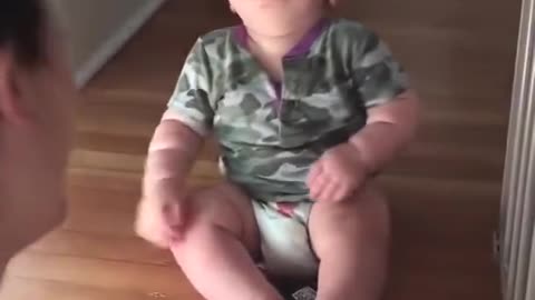 baby laughing looking at his mothers glasses