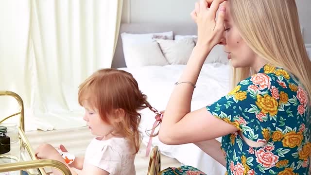 Mother Tying Her Daughter's Hair