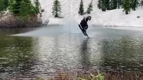 skateboard flying over lake