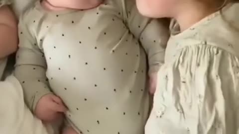 Beautiful scene of sisters taking care of little brother while he sleeps