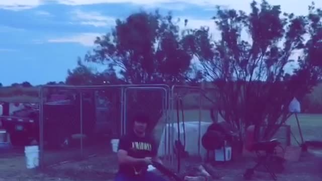 Guy black shirt holding gun mumbling words