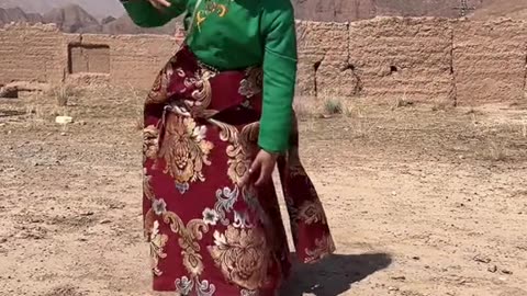 Cute Tibetan little lady is dancing in their tradition