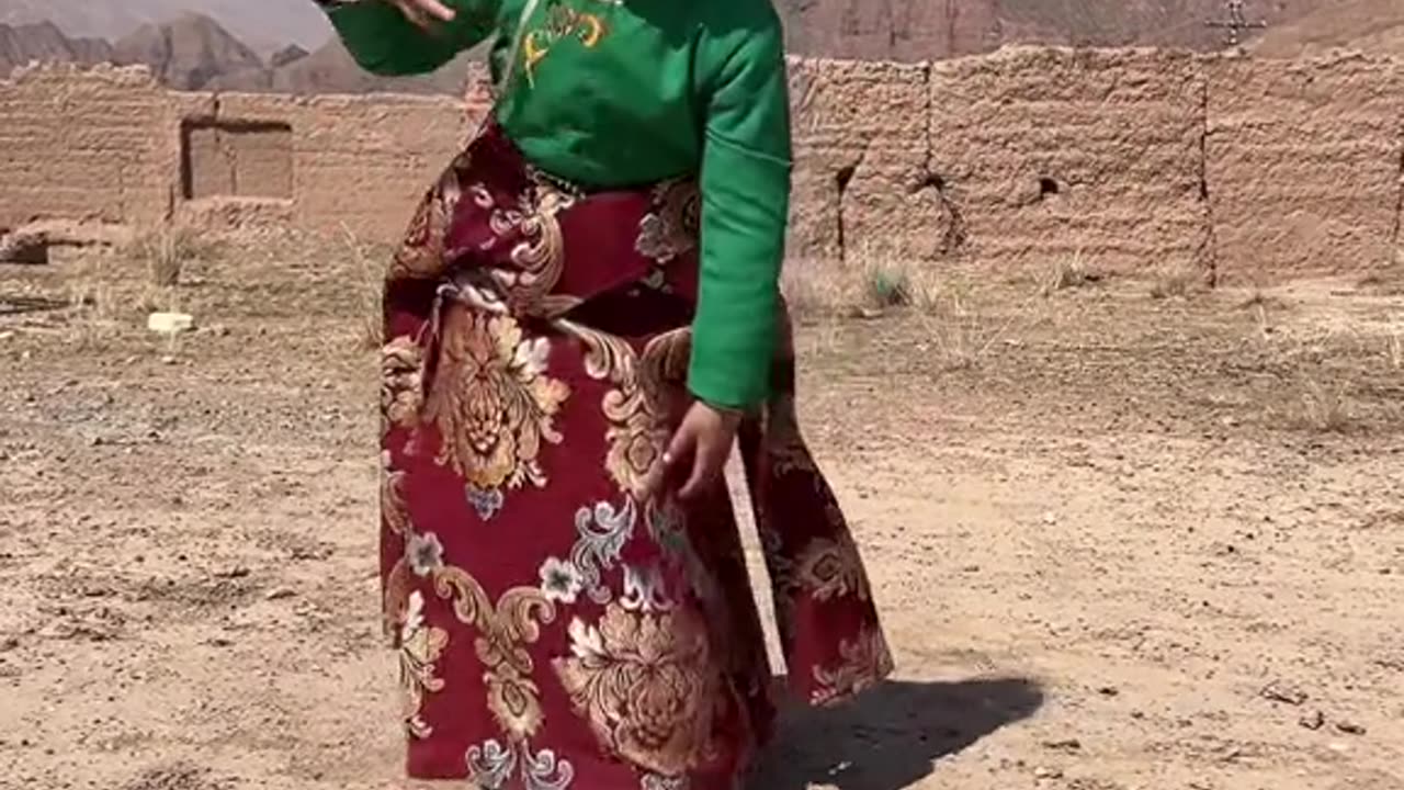 Cute Tibetan little lady is dancing in their tradition