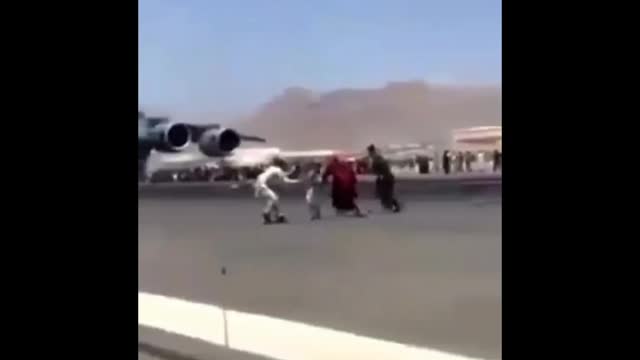 Afghans are clinging onto a C17 transporter on karzia Hamid Airport as they try to escape