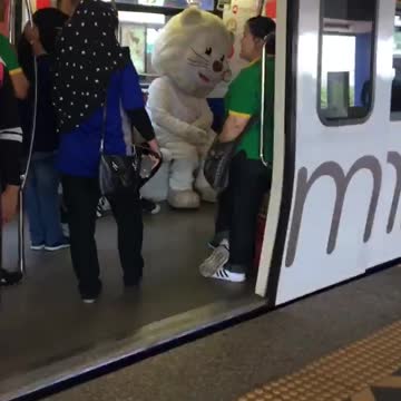 Person in giant white bear costume train