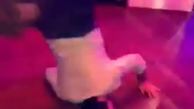 Music guy trying to do the worm at a club
