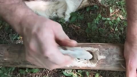 Making an axe from stones in the snow