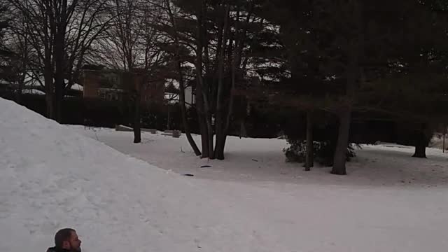 Guy in blue jacket shirt goes down snow hill falls backwards and folds scorpion