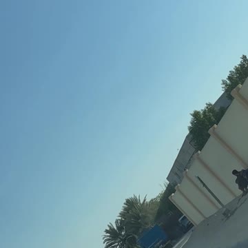 Poor laborers waiting for charity food on the road side in Sharjah