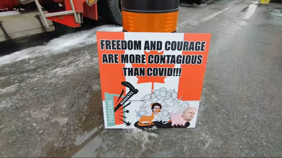 Ottawa Freedom Convoy banner: Freedom and courage are more contagious than covid