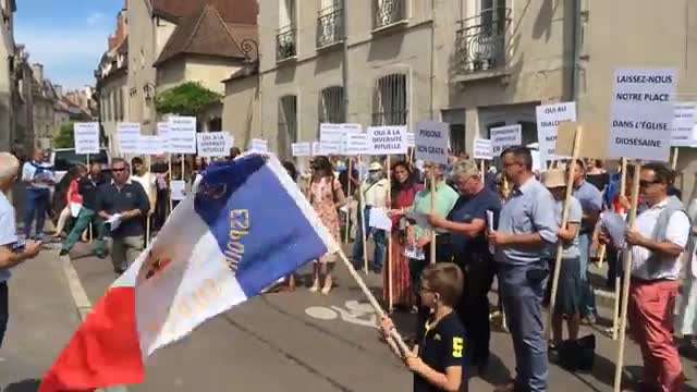 Dijon Latin Mass Catholics sing outside the archbishop's house