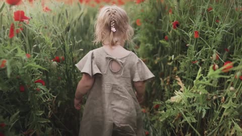 A little girl walking in the grass