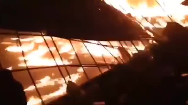 Ukrainian people throw Molotov cocktails at Russian armored vehicles