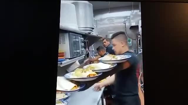 This waiter knows how to carry plates!