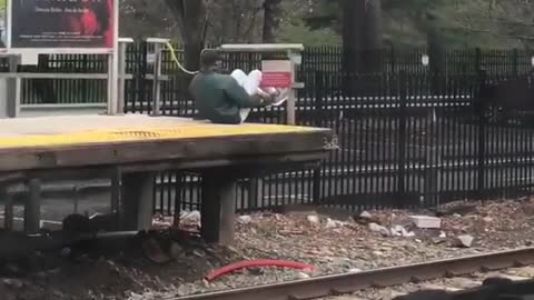 Man green jacket works out on train platform