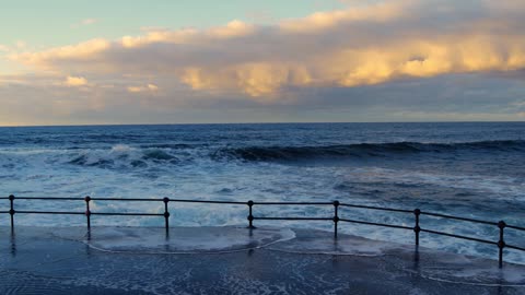 Sea waves hit the embankment