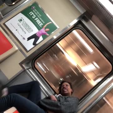 Woman in grey slaps stomach and talks gibberish