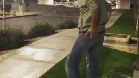 Guy tries to swing on street sign