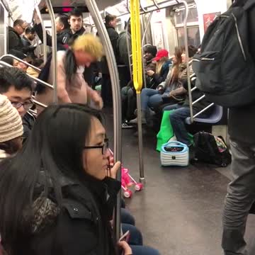Man with donald trump mask acts crazy with baby stroller on subway train