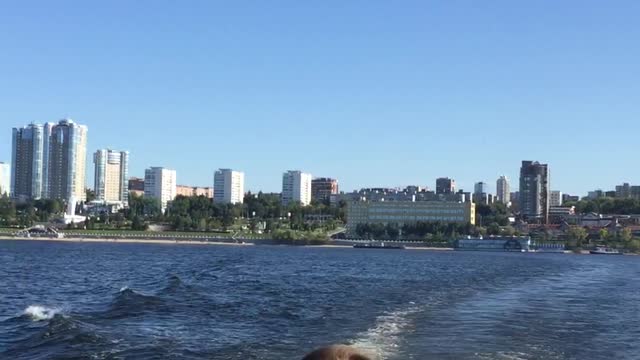 Young man’s boat ride on the Volga river with a beautiful view