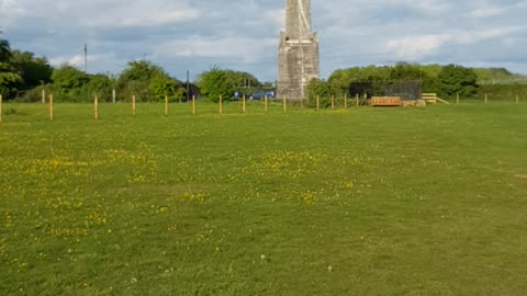 Walking towards an obelisk.