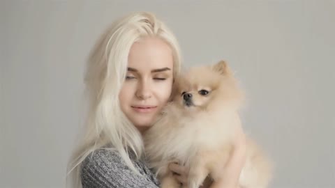 Beautiful Blonde Woman With Her Spitz Isolated On Grey