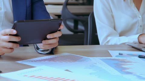 Office workers hands typing on their devices