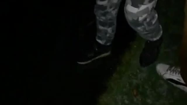 Guy camo pants steps on ice water lake breaks ice and almost falls in