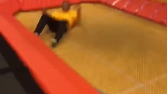 Guy in yellow sweater tries to do front flip and fails