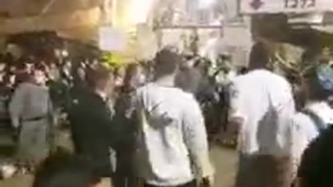 Terrorists in uniform beating a Jew at Meron