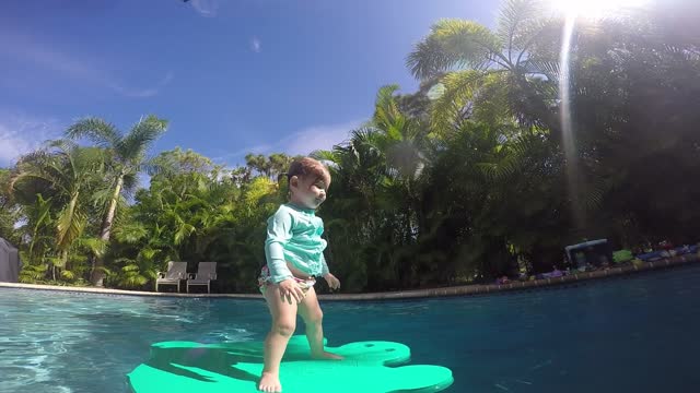 Cute little girl jumping into pool and floating!